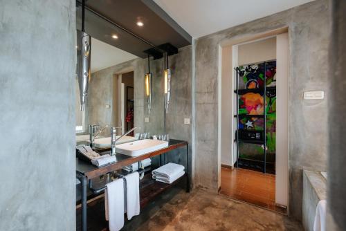 Viva Dash Hotel Seminyak في سمينياك: حمام مع حوض ومرآة