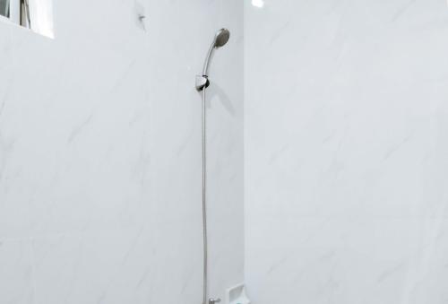 a shower stall with a shower head on a wall at RedDoorz @ RSL Transient House Iloilo in Iloilo City