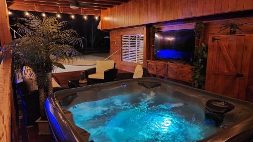a large hot tub in a room with a tv at Palm's Luxury Suite with Private Jacuzzi in Aguada