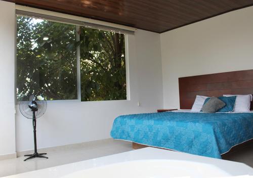 Ένα ή περισσότερα κρεβάτια σε δωμάτιο στο Finca Hotel Villa Gladys en Mesitas del Colegio