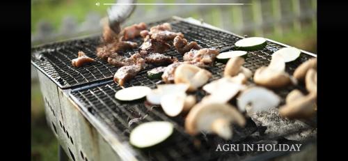 a group of mushrooms and meat on a grill at Agri In Holiday in Hirosaki