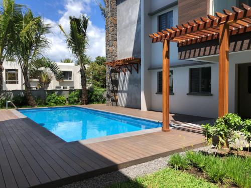 una piscina frente a una casa en Montecrista Appart moderne et cosy, 1 chambre à 2 min plage Pereybere, en Pereybere