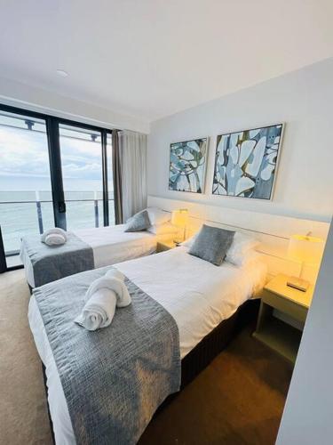 Habitación de hotel con 2 camas y ventana grande. en Soul Luxury Apartment’s, en Gold Coast