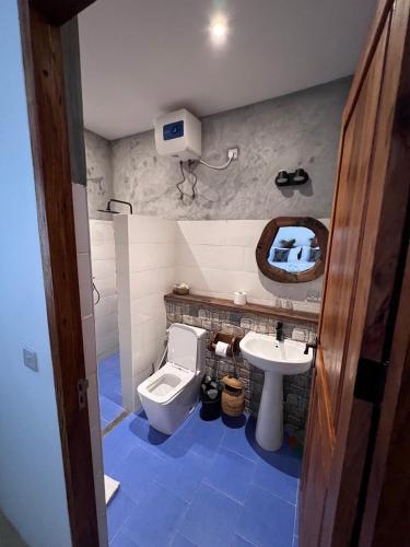 a bathroom with a toilet and a sink at The View of Zanzibar in Michamvi