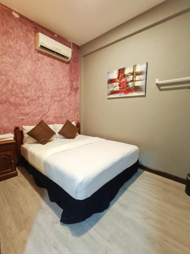 a bedroom with a large white bed in a room at Tc theme park Guest house in Kuantan