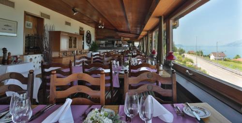 a dining room with tables and chairs in a train at Hotel Kreuz in Leissigen