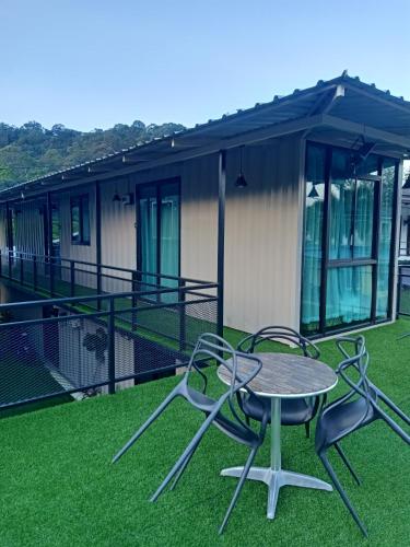 a patio with a table and chairs in front of a house at Tc theme park Guest house in Kuantan