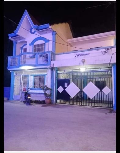 a blue building with a gate in front of it at JW Apartments in Angeles