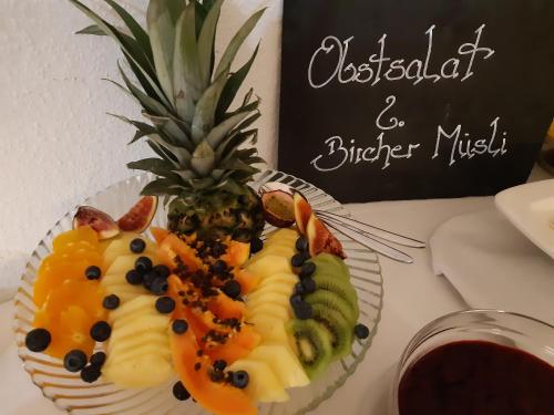 a fruit salad on a plate on a table at Schwarzwaldhotel Sonne in Baden-Baden