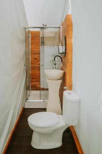 a bathroom with a toilet and a shower at Glamping tent in Pelaga Eco Park in Patjung