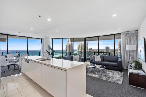 a kitchen and living room with a view of the ocean at Oracle Resort Broadbeach - gclr in Gold Coast