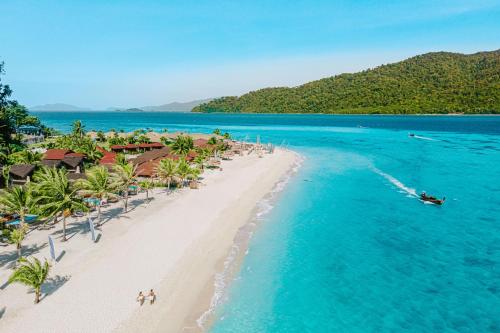 an aerial view of a beach with a boat in the water at Irene Pool Villa Resort, Koh Lipe in Ko Lipe