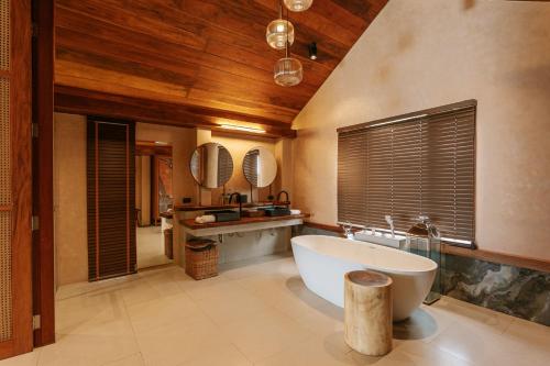 a bathroom with a large tub and a sink at Irene Pool Villa Resort, Koh Lipe in Ko Lipe