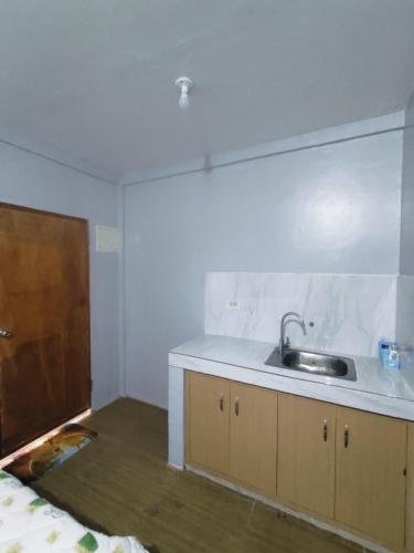 a kitchen with a sink and a counter top at JLF Inn in Locsin