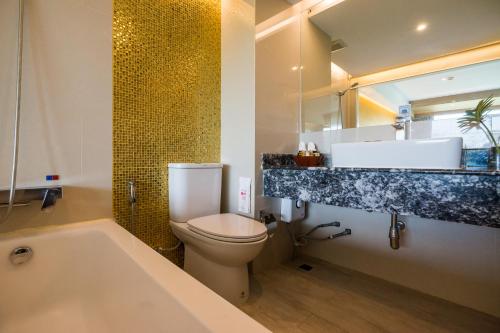 a bathroom with a toilet and a sink and a tub at MATCHA SAMUI RESORT formerly Chaba Samui Resort in Chaweng