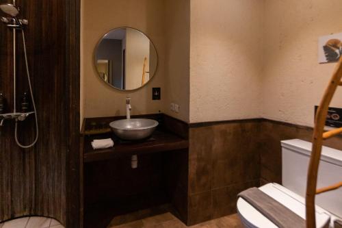 a bathroom with a sink and a mirror at Tanaga CoLiving in Seminyak