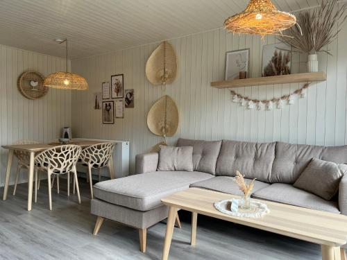 a living room with a couch and a table at Ferienhaus am See in Parey