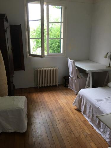 a room with two beds and a desk and a window at Villa Gif Sur Yvette centre - Paris Olympic game 2024 visitors in Gif-sur-Yvette