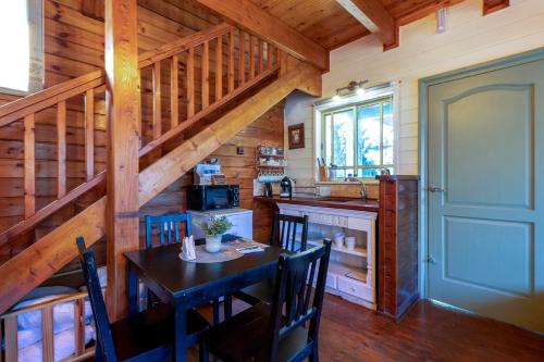 a kitchen with a table and chairs in a cabin at Sea of Galilee Panoramic View in Moshav Ramot