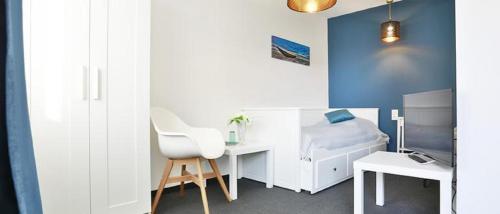 a bedroom with a white desk and a white chair at Der Piestingerhof in Markt Piesting