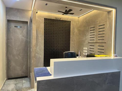 a bathroom with a vanity with a large mirror at HOTEL SUNRISE in Vadodara