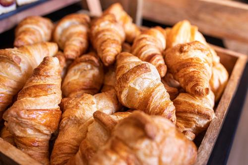 a pile of croissants and croissantsearcher at LOGINN Hotel Waiblingen in Waiblingen