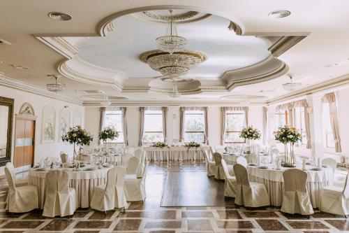 un salón de banquetes con mesas y sillas y una lámpara de araña en Hotel Szyndzielnia Eco, en Bielsko-Biala