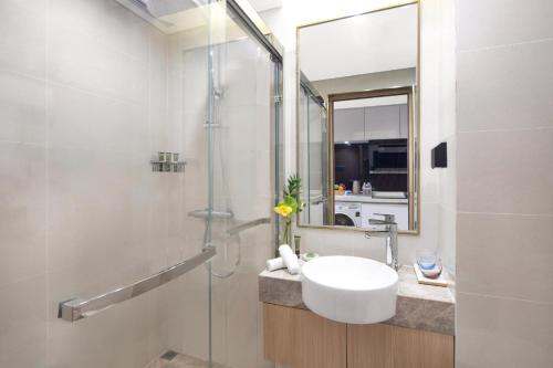 a bathroom with a sink and a shower at Eature Residences Lingang in Shanghai