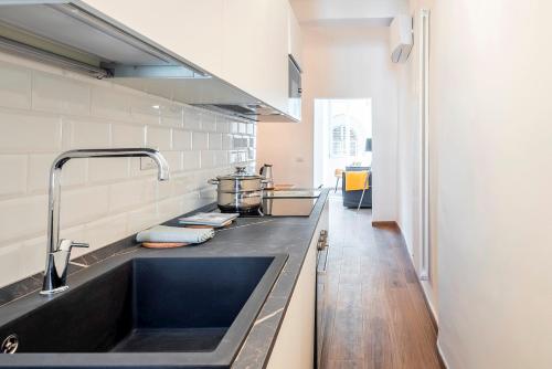 a kitchen with a sink and a counter at Alloro Apartment in Florence