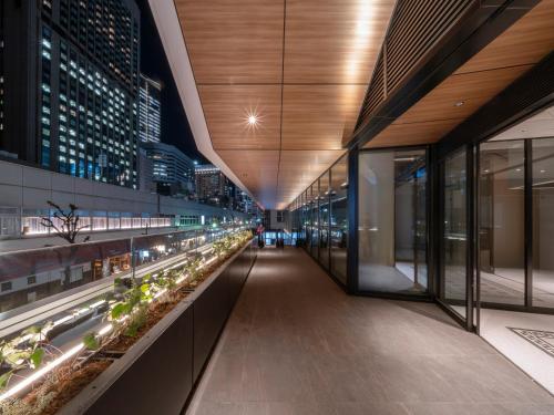 an empty corridor in a building at night at GINZA HOTEL by GRANBELL in Tokyo