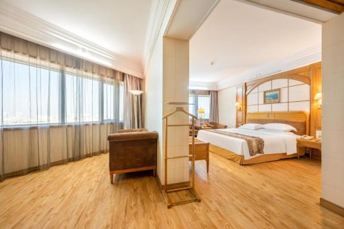 a hotel room with a bed and a desk at Hotel Silverland in Dongguan