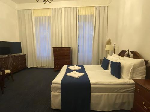 a hotel room with a large bed and a desk at OPERA16 Guestrooms in Budapest