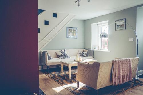 a living room with a couch and a table at Maytown Cottage in Rosslare