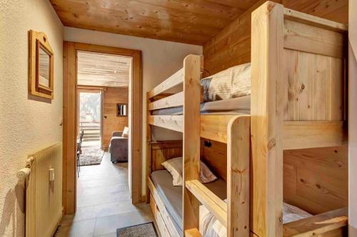 a room with two bunk beds in a cabin at Beauregard 2 in Le Grand-Bornand