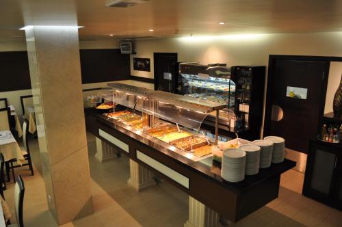 a buffet line with many different types of food at Hotel Aleluia in Fátima