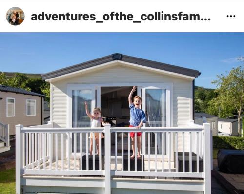 two children standing on the balcony of a tiny house at Number 57 Brynteg in Caernarfon