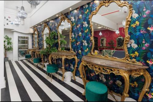 a room with a row of dressing tables and mirrors at Spacious Liverpool Party Pad with 4 Bedrooms! in Liverpool