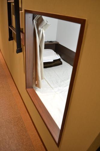 a mirror reflection of a bed in a room at 1 Night 1980 Hostel Tokyo Asakusa Simple Stay in Tokyo