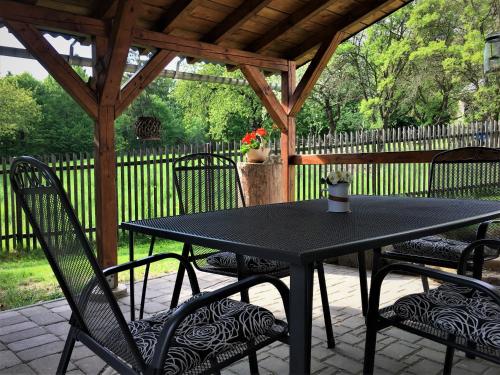 a black table and chairs under a gazebo at Ubytování Pod lázněmi Klimkovice in Klimkovice