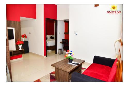 a living room with a couch and a table at Hotel Omicron 1 BHK Studio room in Bengaluru