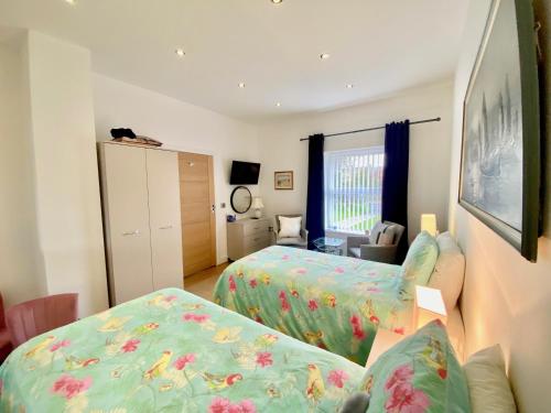 a hotel room with two beds and a bedroom at Witheys Lodge in Woodhorn