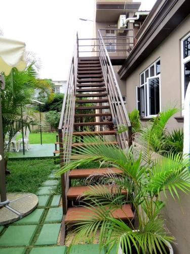 a staircase leading up to a house with plants at Swan Valley Residence in Baie du Tombeau