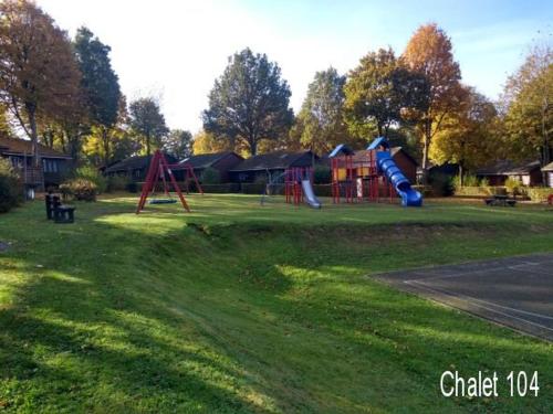 a playground with a slide in a park at La Boverie, Chalet 104 in Rendeux