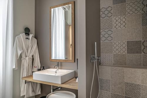 a bathroom with a sink and a mirror at LEONI DI COLLALTO PALACE in Treviso