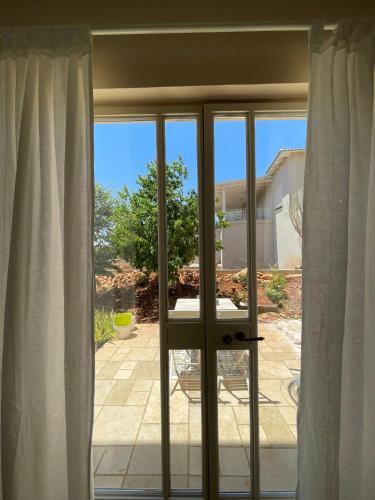 a sliding glass door with a view of a patio at שלווה בהר in Malkiyya