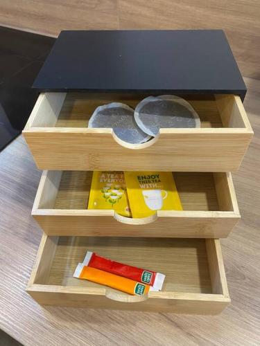 a wooden box with threeartmentsacersacersacersacersngthngthngthngthngthngth at L'Atelier d'Emilie in Bessines
