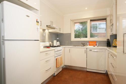 eine Küche mit weißen Geräten und einem weißen Kühlschrank in der Unterkunft Lisson Holiday Rental in Melbourne