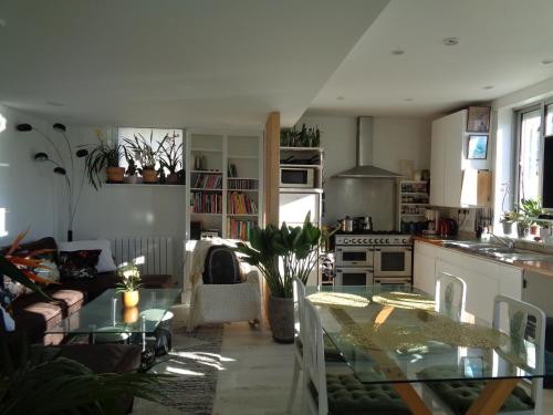a kitchen and living room with a table and a couch at vacances 34 in Le Crotoy