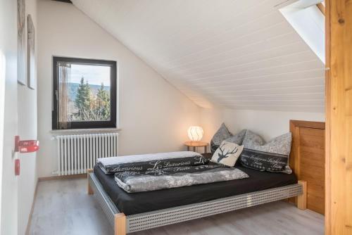 a bedroom with a bed and a window at Ferreira's Loft - Ferienwohnung in St. Blasien