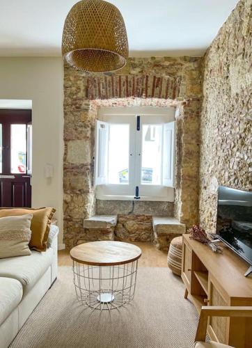 a living room with a couch and a table at Olivete Apartment in Lisbon